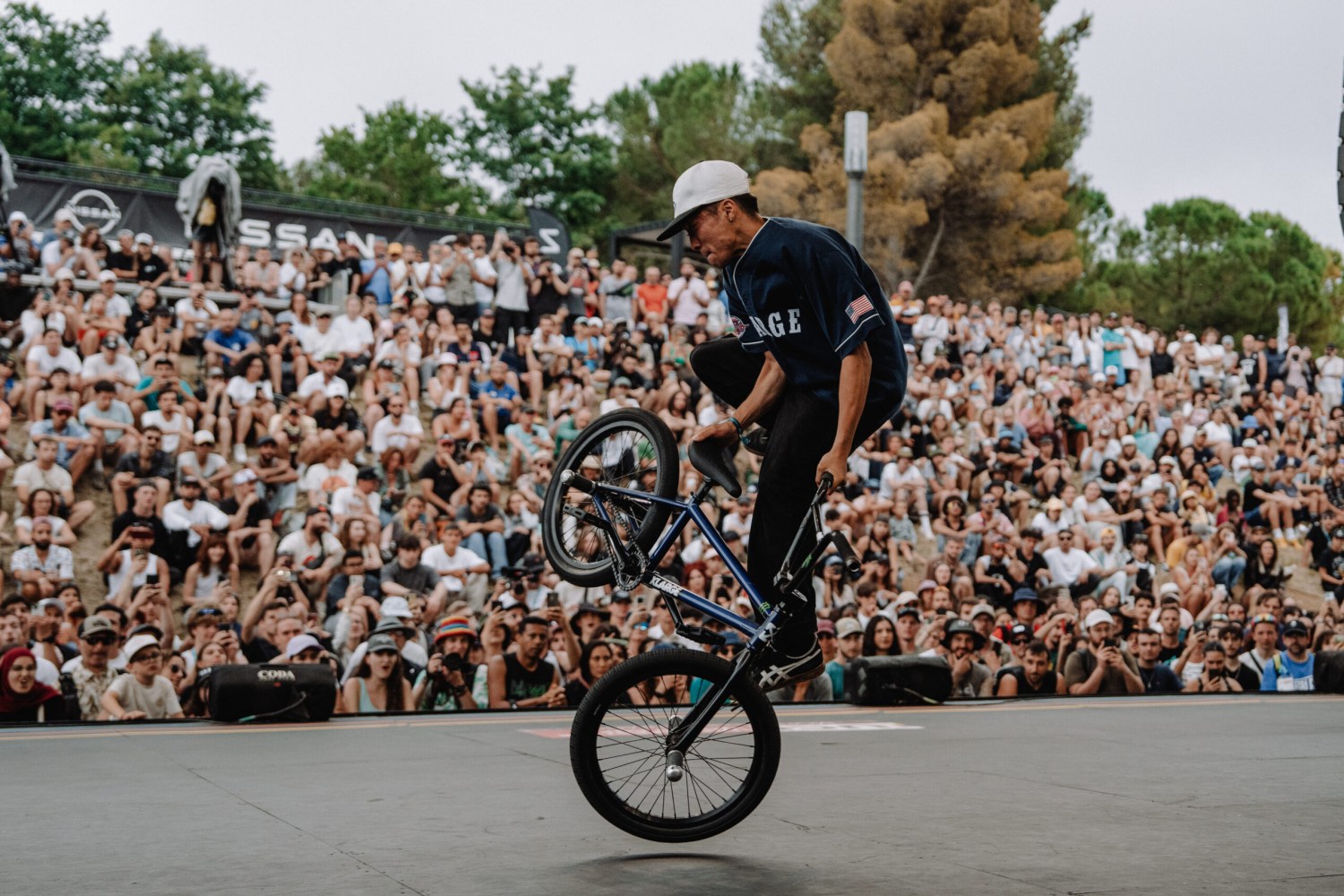 Everything you need to know about FISE in Birmingham Aug 7-9: world-class sports, live music + more 1 BMX rider performing a wheelie trick in front of a large crowd at an outdoor competition