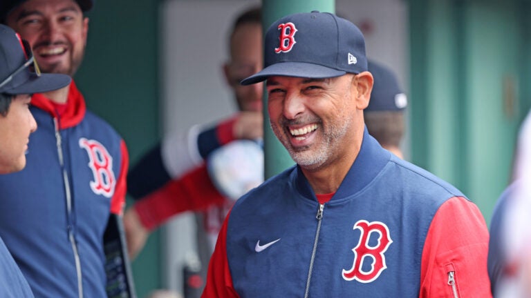 Boston Red Sox manager Alex Cora is all smiles in the dugout during his team's three run seventh inning during a baseball game against the Detroit Tigers, Monday, April 20, 2026 in Boston.