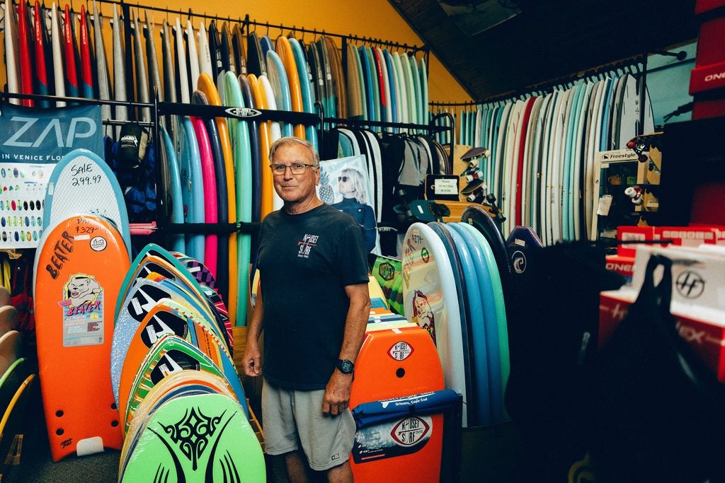 Phil Clark, owner of the Nauset Surf Shop in Cape Cod, Mass., July 26, 2026. Over the last several years, a resurgent seal population has turned Cape Cod into one of the world’s top seasonal hot spots for great white sharks. 
