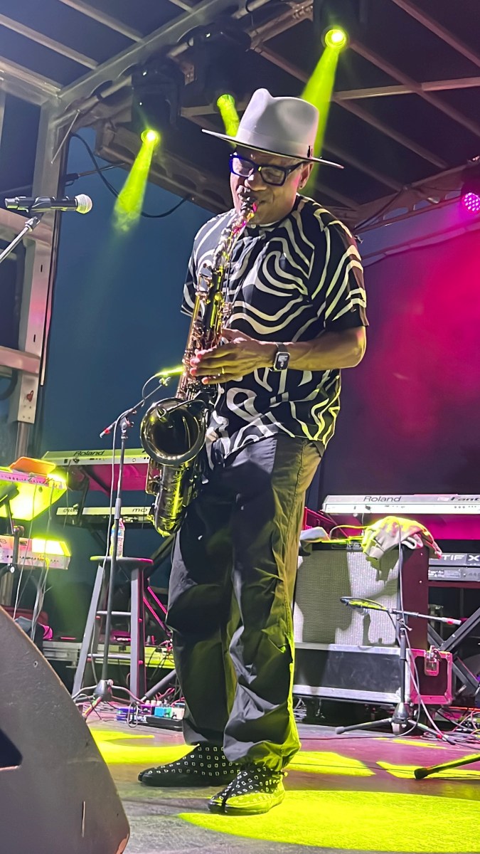 FREE Irondale Music Fest 2026: Tony Tatum + more 3 Tony Tatum playing saxophone on stage in a fedora, under green stage lights