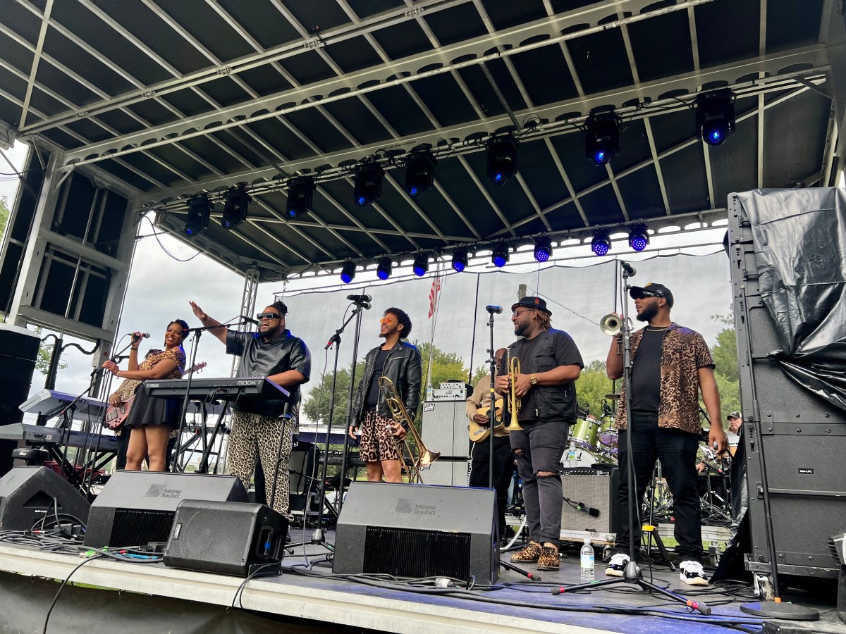 FREE Irondale Music Fest 2026: Tony Tatum + more 1 Tony Tatum performing outdoors with band members on keys, brass and vocals at an outdoor festival stage