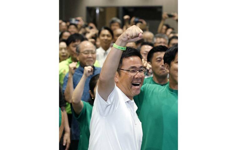 KYODO/VIA REUTERS
                                Genta Koja celebrates after winning the Okinawa gubernatorial election in Naha, Okinawa Prefecture, Japan, on Sept. 13, in this photo taken by Kyodo.