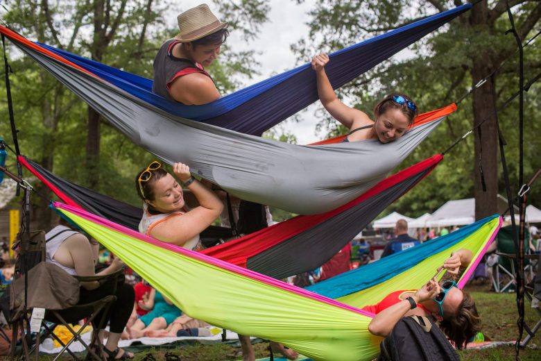 Festival attenees hang out in the hammocks they set up above the area called the Meadow Stage on Saturday July 4, 2015 at the 36th Annual Festival for the Eno. Photo by Alex Boerner.
