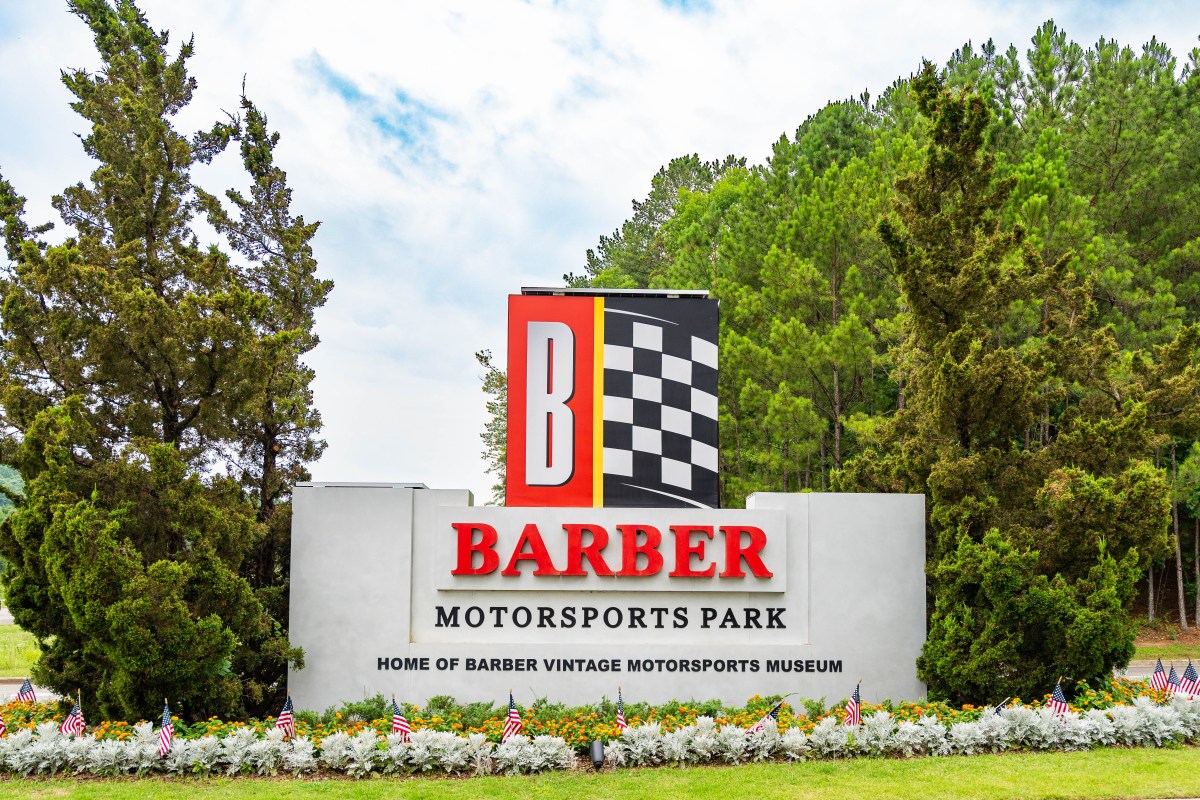 13 car shows happening across Greater Birmingham 3 Entrance sign for Barber Motorsports Park, Home of Barber Vintage Motorsports Museum, with American flags lining the flower bed below