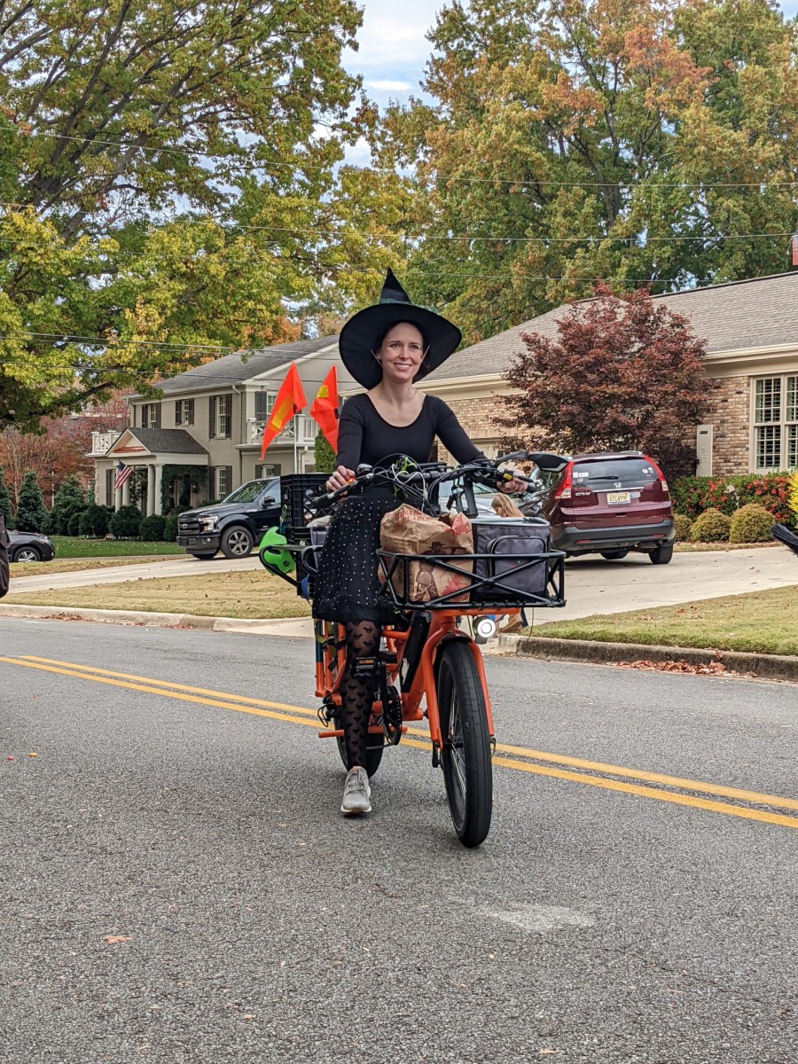 women on bike taking part in witches ride event