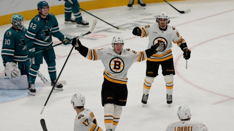 Boston Bruins center Fraser Minten, middle, celebrates after scoring against the San Jose Sharks during the third period of an NHL hockey game, Tuesday, Oct. 13, 2026, San Jose, Calif.