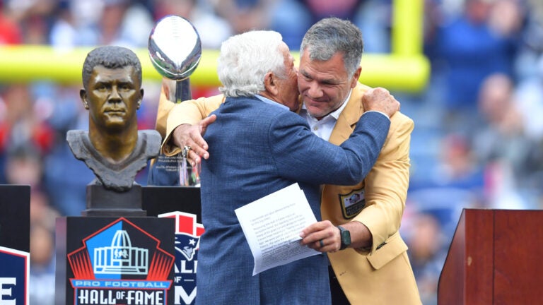 Former New England Patriots kicker Adam Vinatieri, right, gets a hug from team owner Robert Kraft, left, during a halftime ceremony during an NFL football game between the New England Patriots and the Las Vegas Raiders in Foxborough, Mass., Sunday, Oct. 11, 2026.